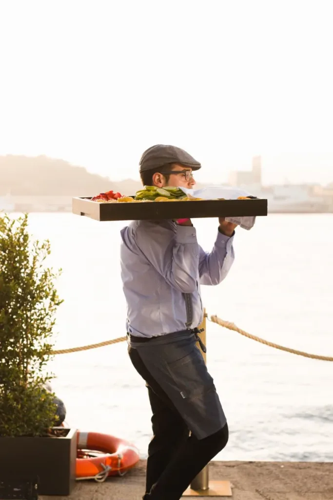 waiter-serving-canapes-by-the-sea svg+xml;charset=utf
